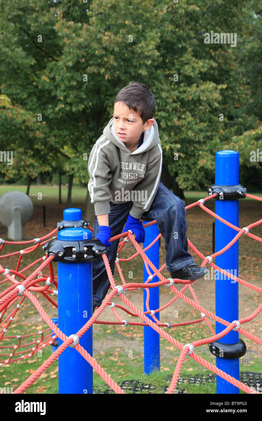 5 year old boy playing on climbing apparatus Stock Photo Alamy