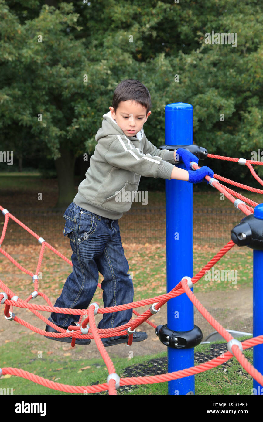 5 year old boy playing on climbing apparatus Stock Photo Alamy