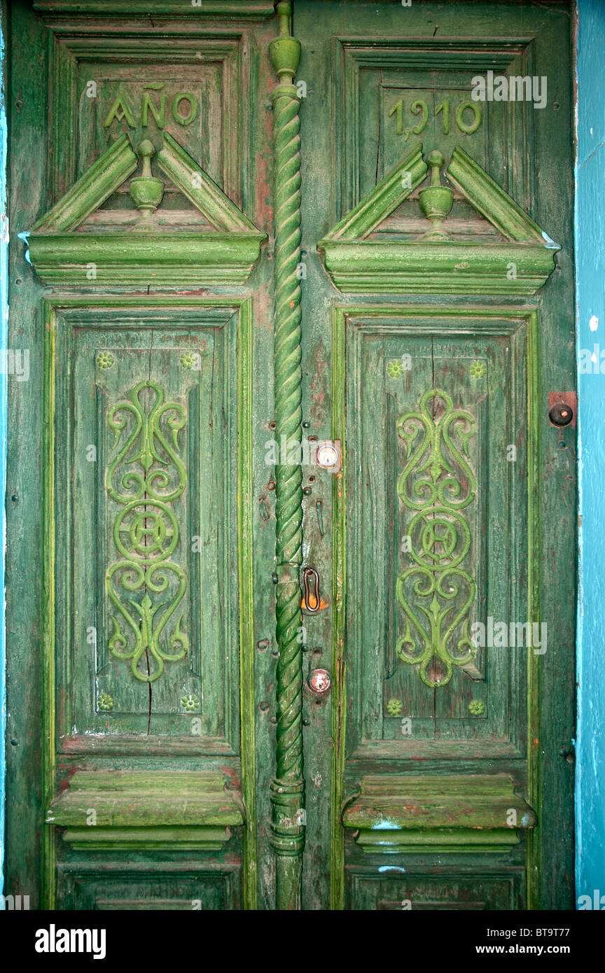 An old, faded, green painted door in the Witches Market street of La Paz, Bolivia. Stock Photo