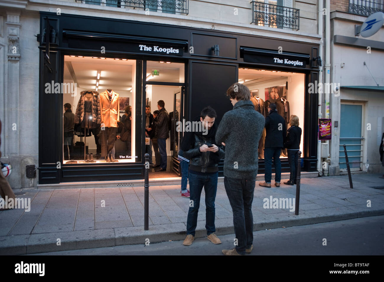 Paris, France, Street Scene, Le Marais District, Men With Cellphones Standing Outside Local Clothing Store, Shop Front 'The Kooples' Local Brand Stock Photo