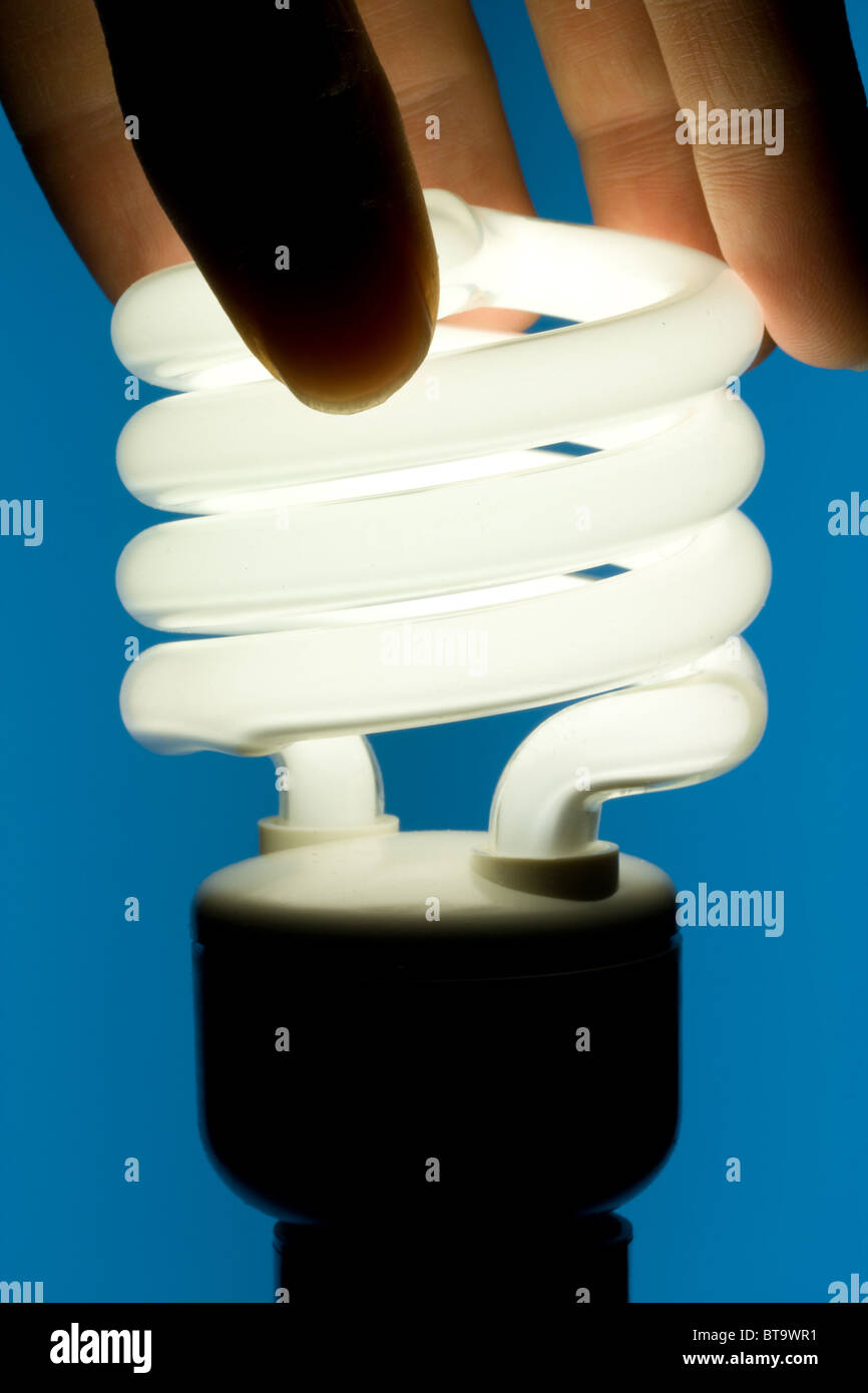 Hand Installing Energy Efficient Fluorescent Light Bulb Stock Photo - Alamy