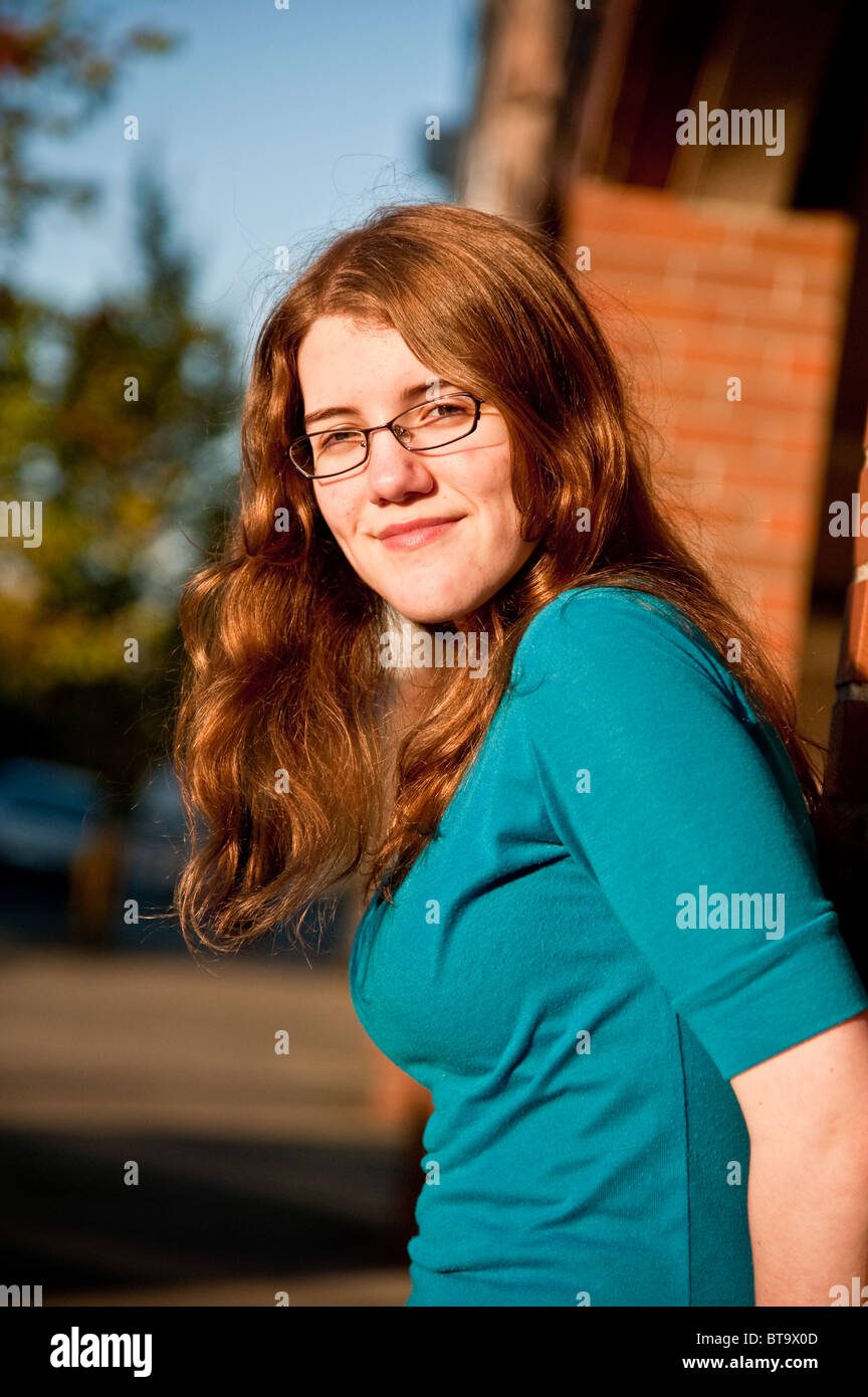 A vertical image of a young Caucasian red hair high school teenage girl Stock Photo
