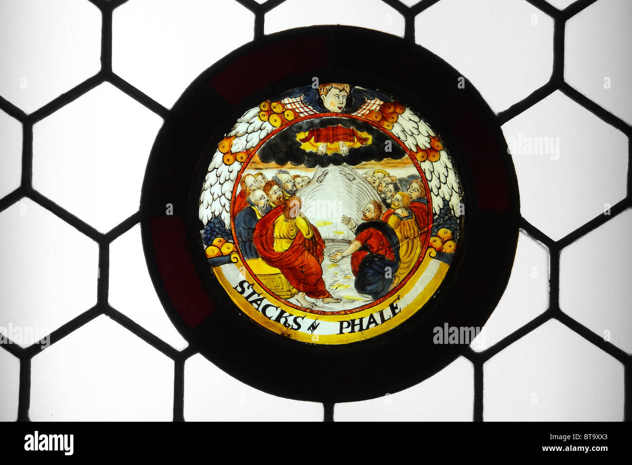 Stained glass roundel with a scene of the ascension in 'honeycomb' type glazing. (roundel 16th century, glazing 19th century). Stock Photo