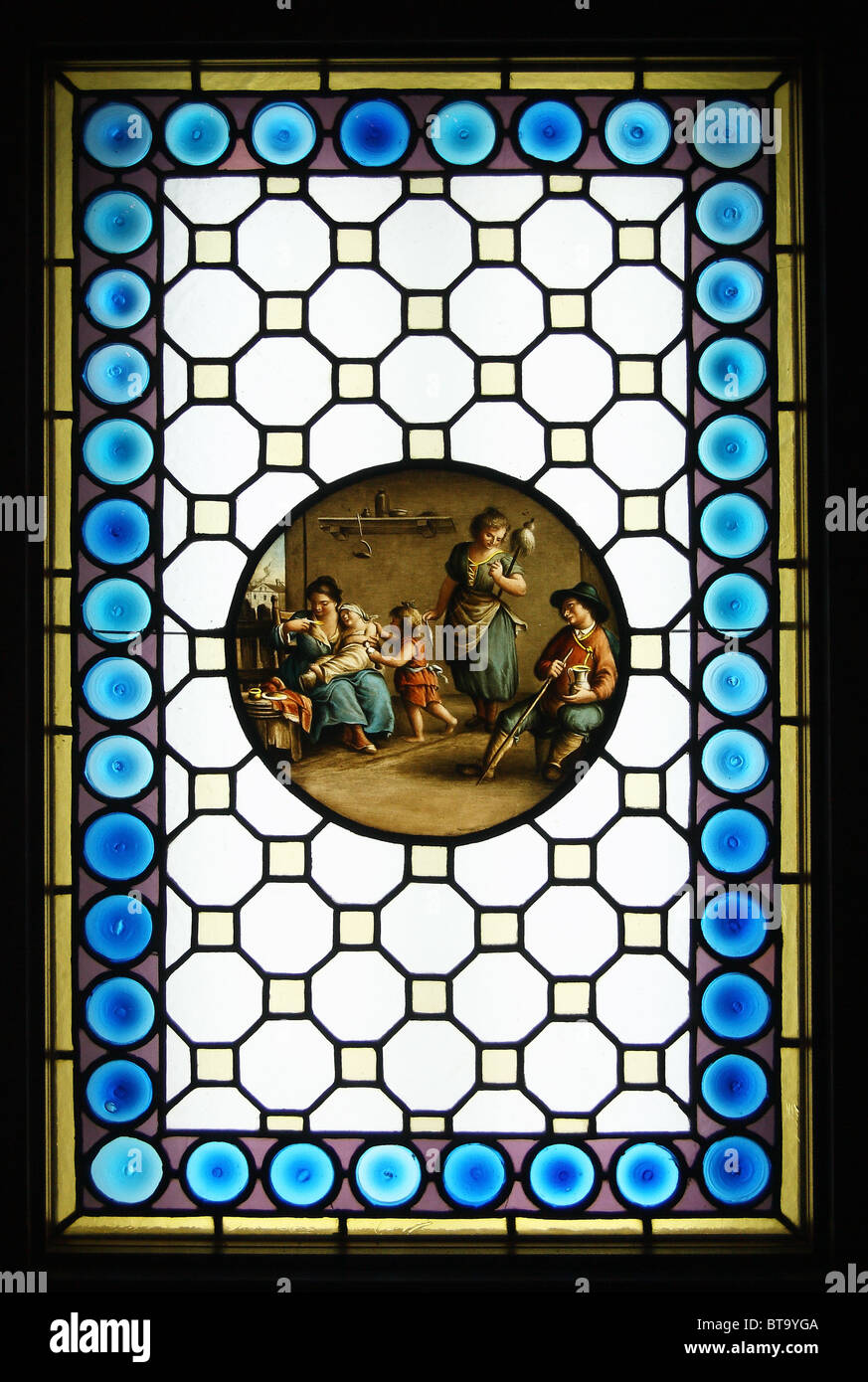 Stained glass window with a painted life scene in tondo (20th century). Museum of Architecture, Wroclaw. Stock Photo
