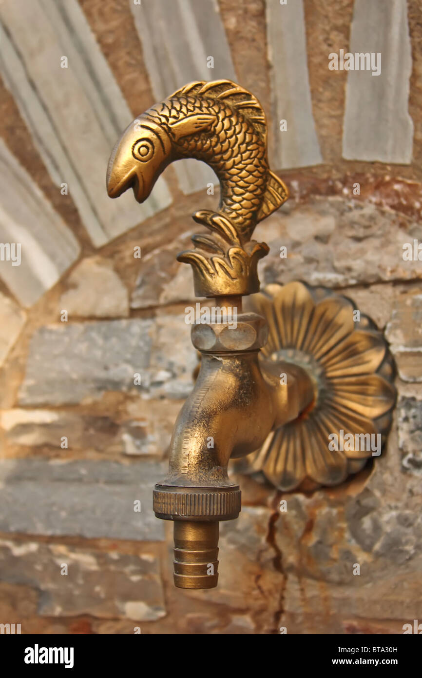 fish shaped faucet in Greek church Stock Photo Alamy