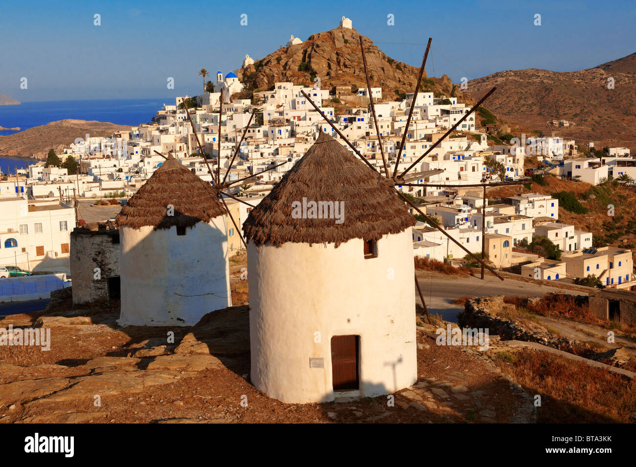 The Windmills overlooking Chora town. Ios Cylcades Islands, Greece. Stock Photo