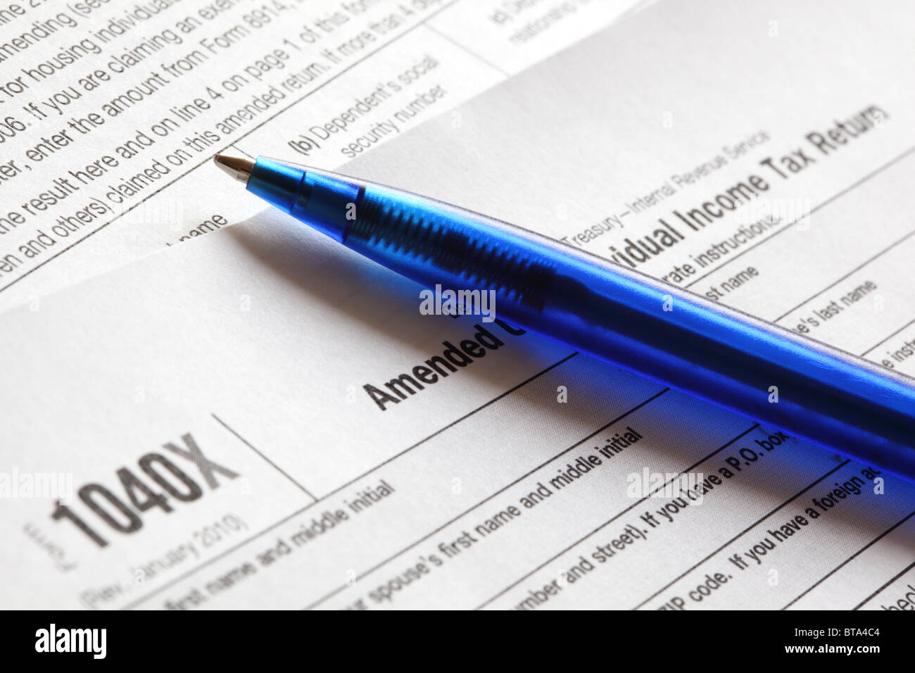 U.S. income tax form 1040X and a blue pen close-up. Shallow DOF. Stock Photo