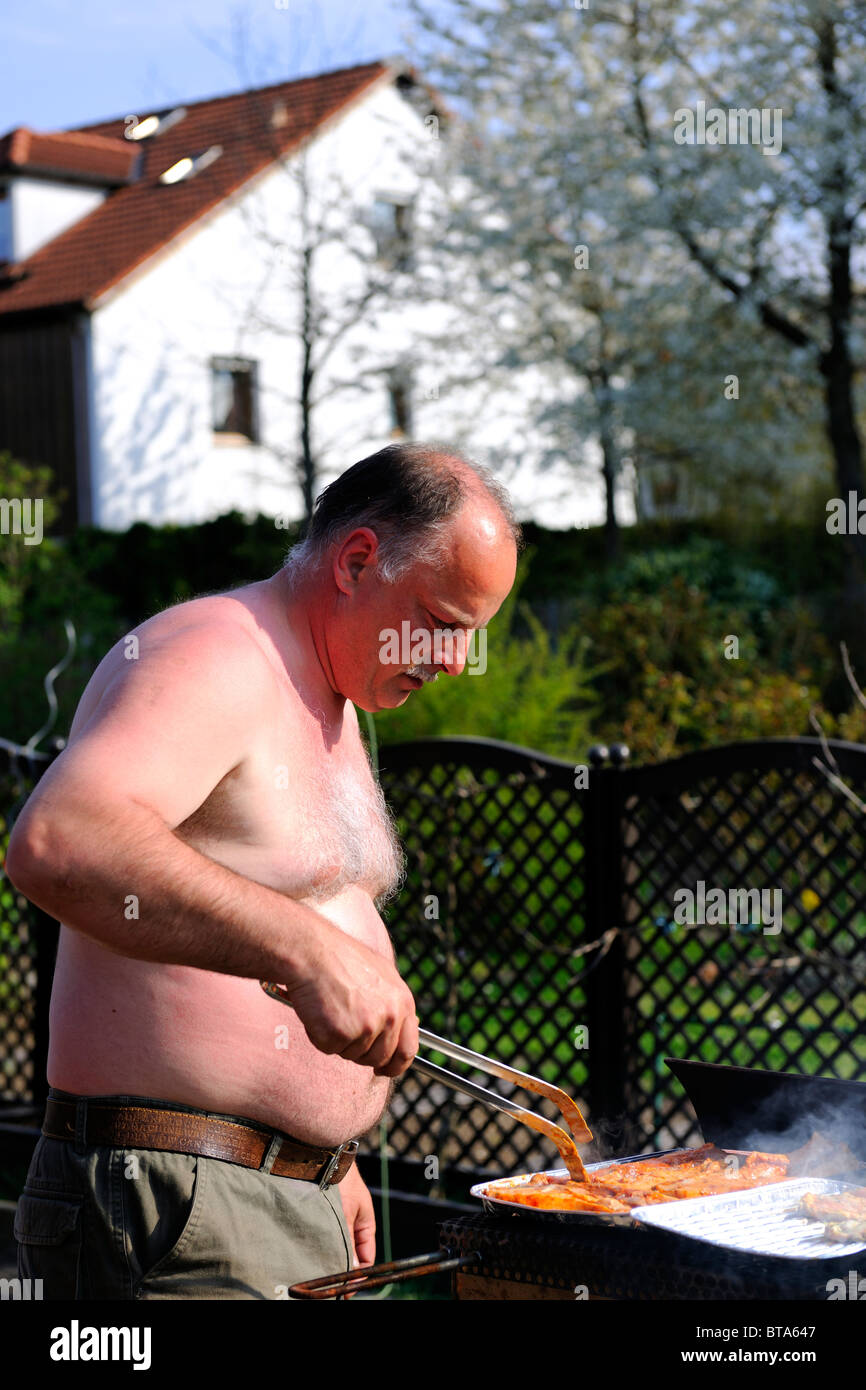 Man grilling in his Garden Stock Photo