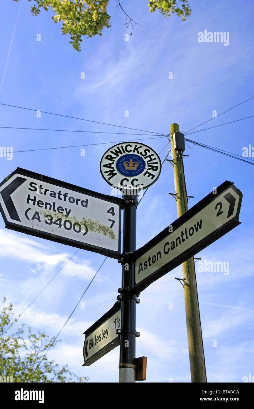 Multiple signs with a Warwick CC Queen's Golden Jubille round top plate Stock Photo