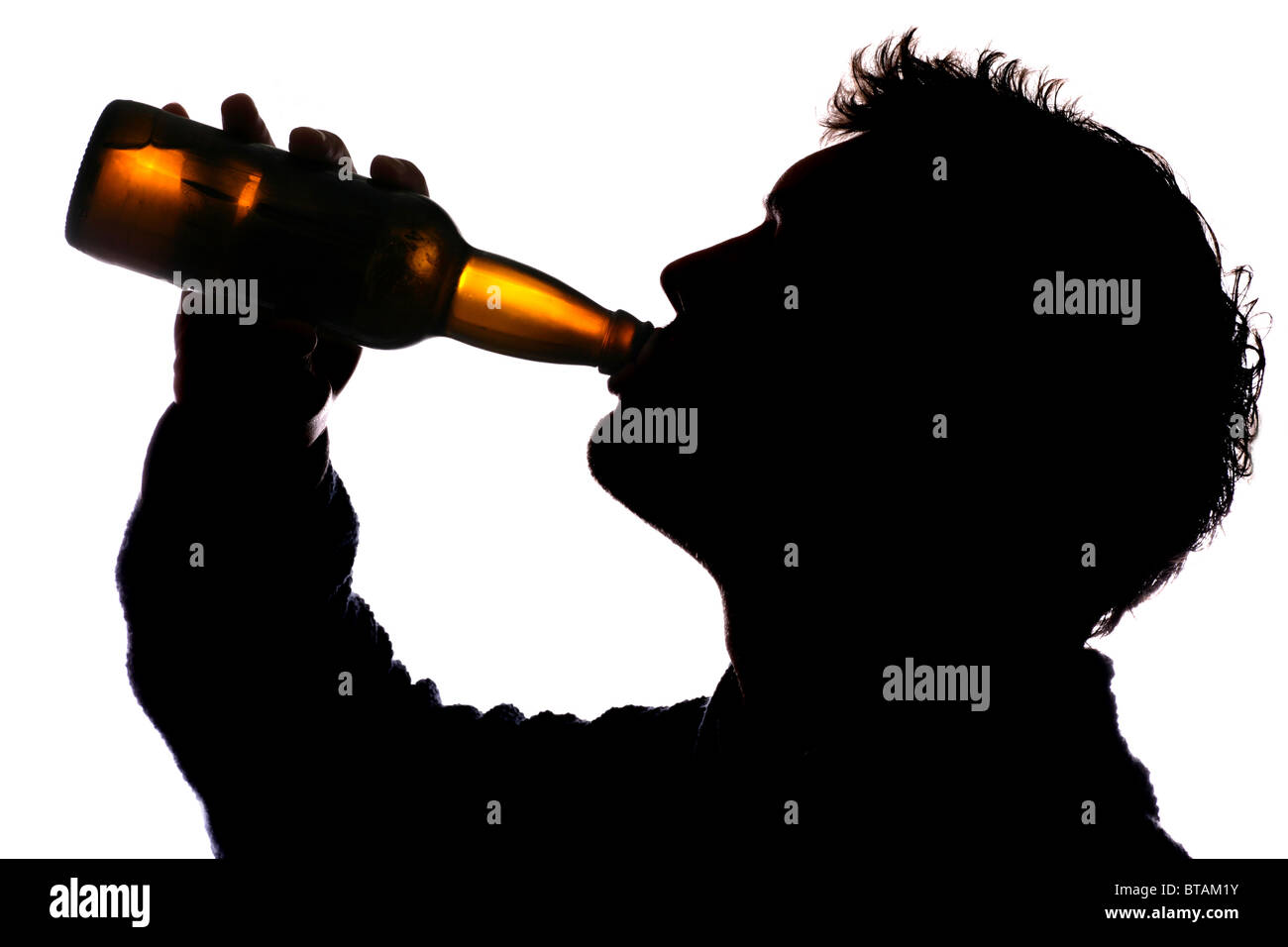 Man drinking bottle of cider silhouette Stock Photo