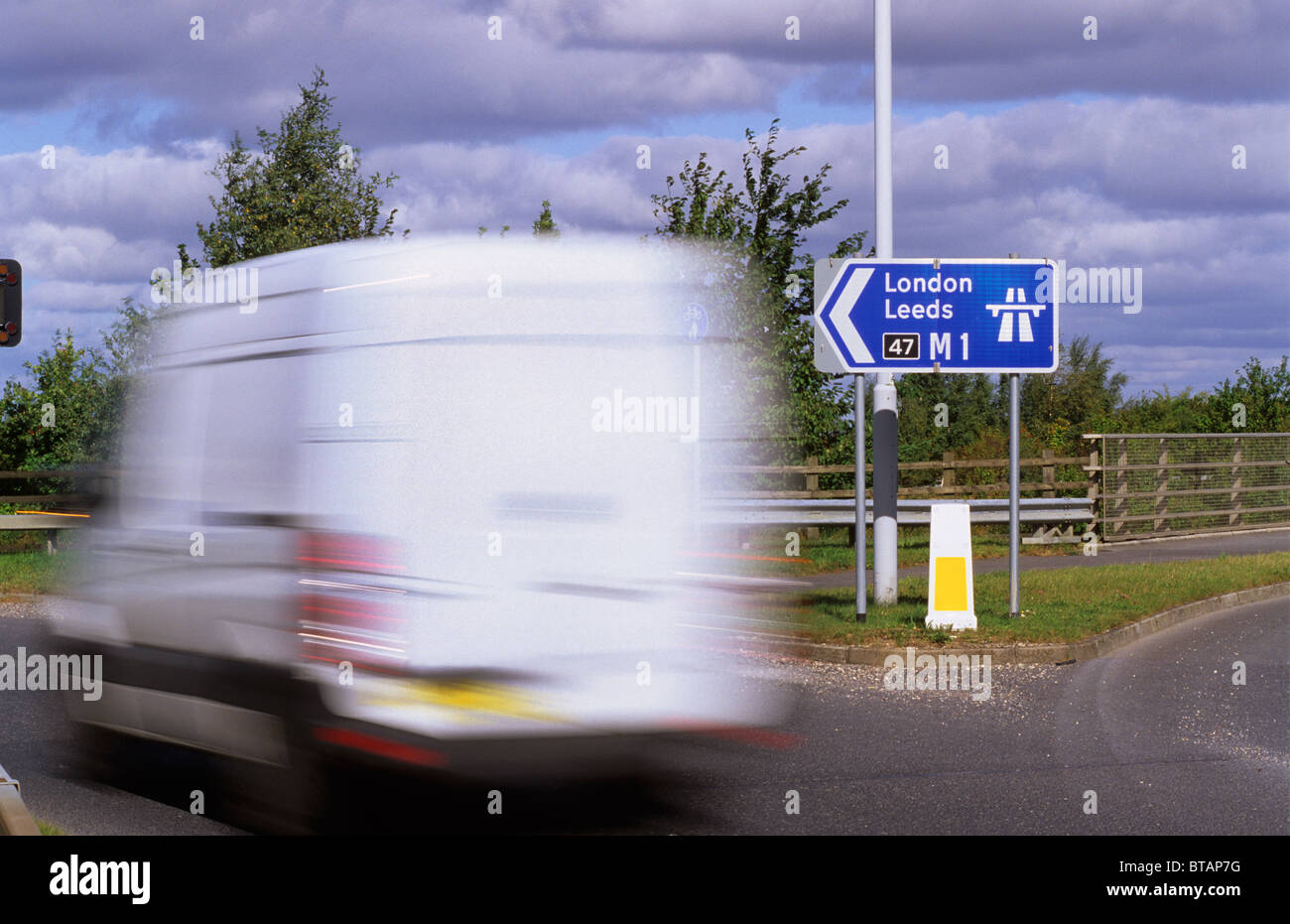 van passing sign showing start of M1 motorway near Leeds Yorkshire UK Stock Photo