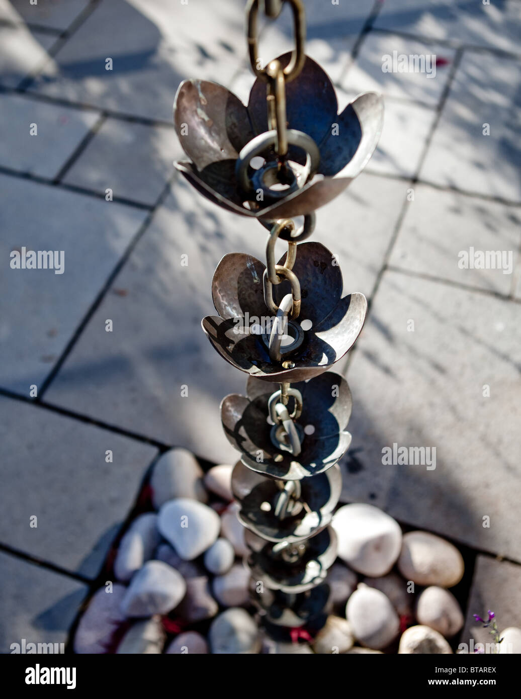 A "Rain Chain" installed instead of a gutter downpipe in an architect