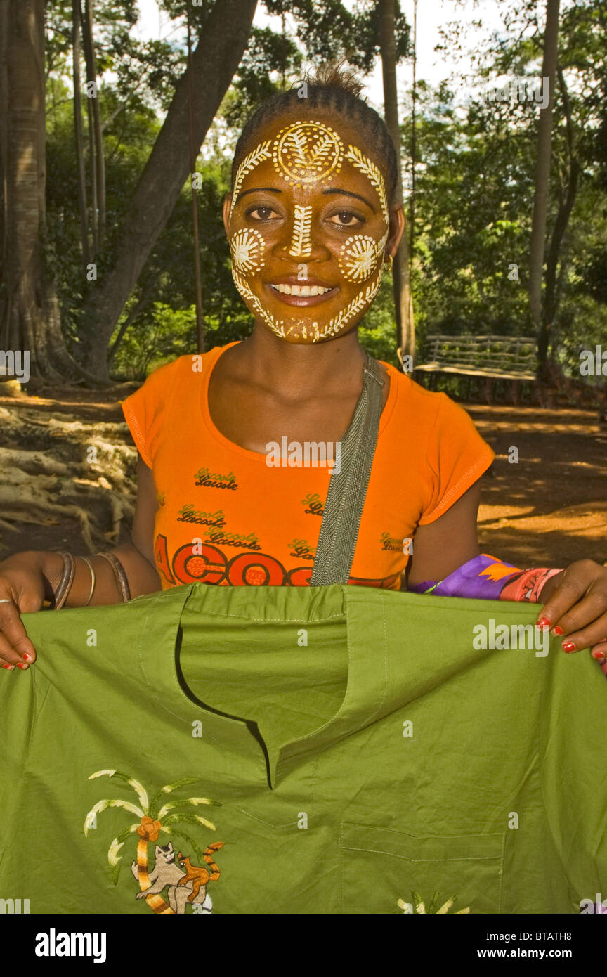 AFRICA MADAGASCAR Nosy Be young girl with decorated face selling clothes Stock Photo