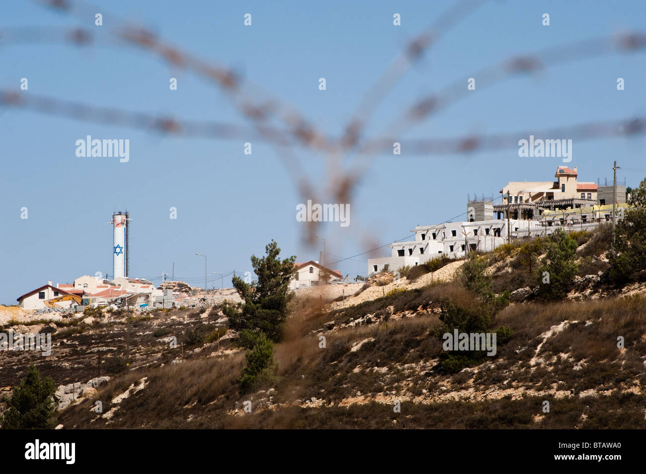 A tower bearing the Star of David rises above Jewish homes in the Neve Daniel section of the Gush Etzion Israeli settlement bloc Stock Photo