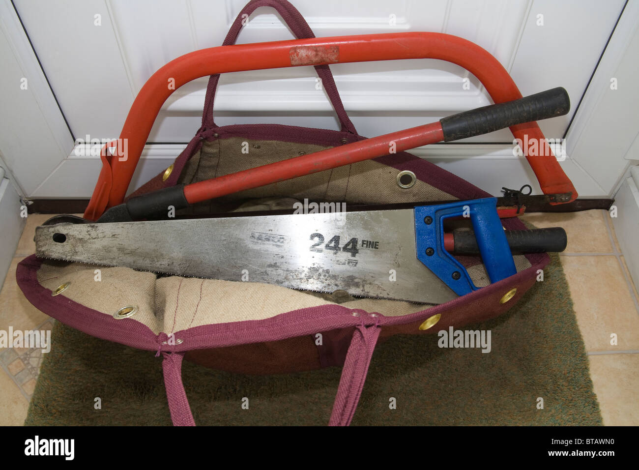 Close up workman's bag bow hand saw red handled loppers Stock Photo - Alamy