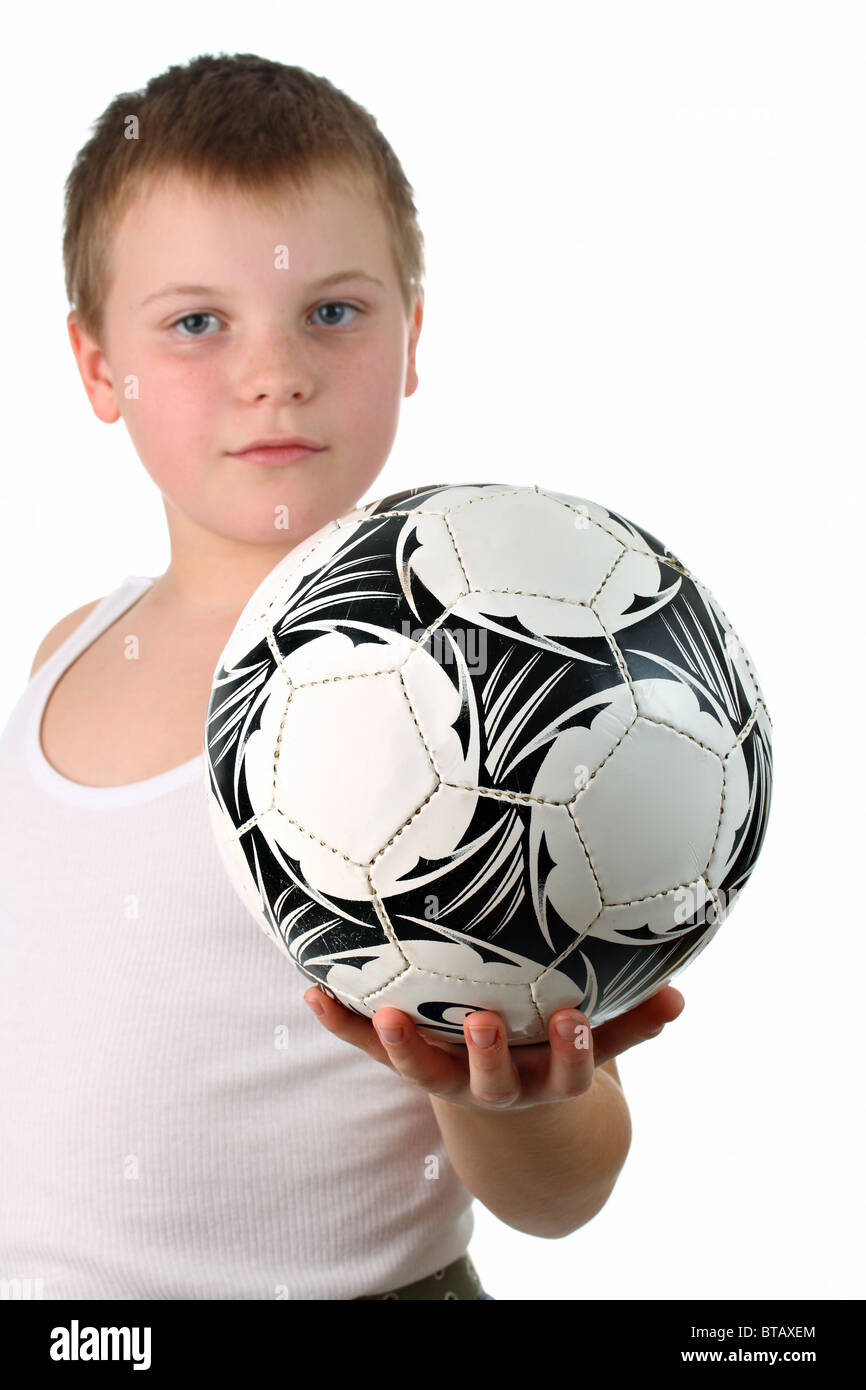 Small boy holding the soccer ball on one hand isolated on white Stock