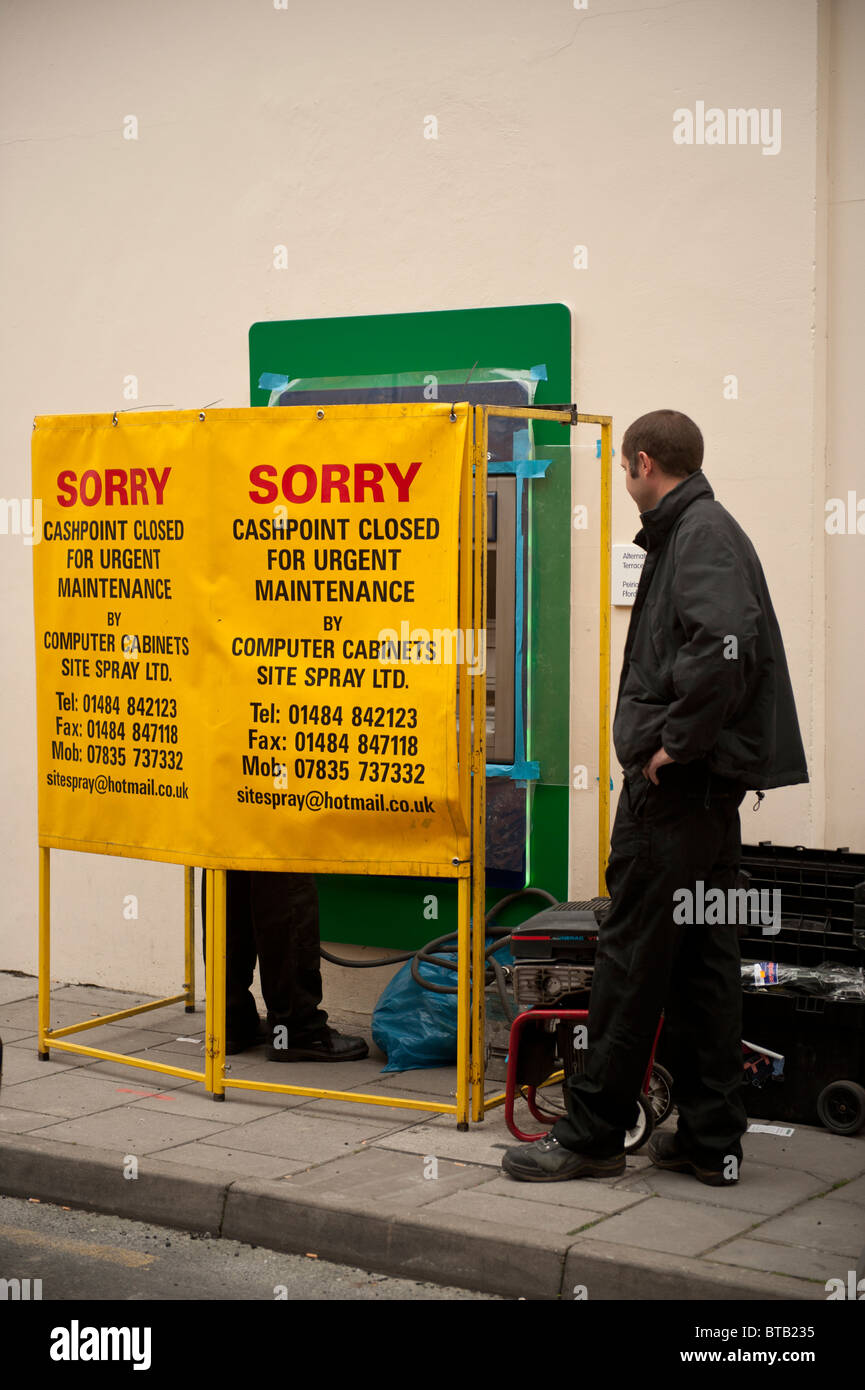 Workmen repairing or maintaining a ATM cash point machine UK Stock Photo