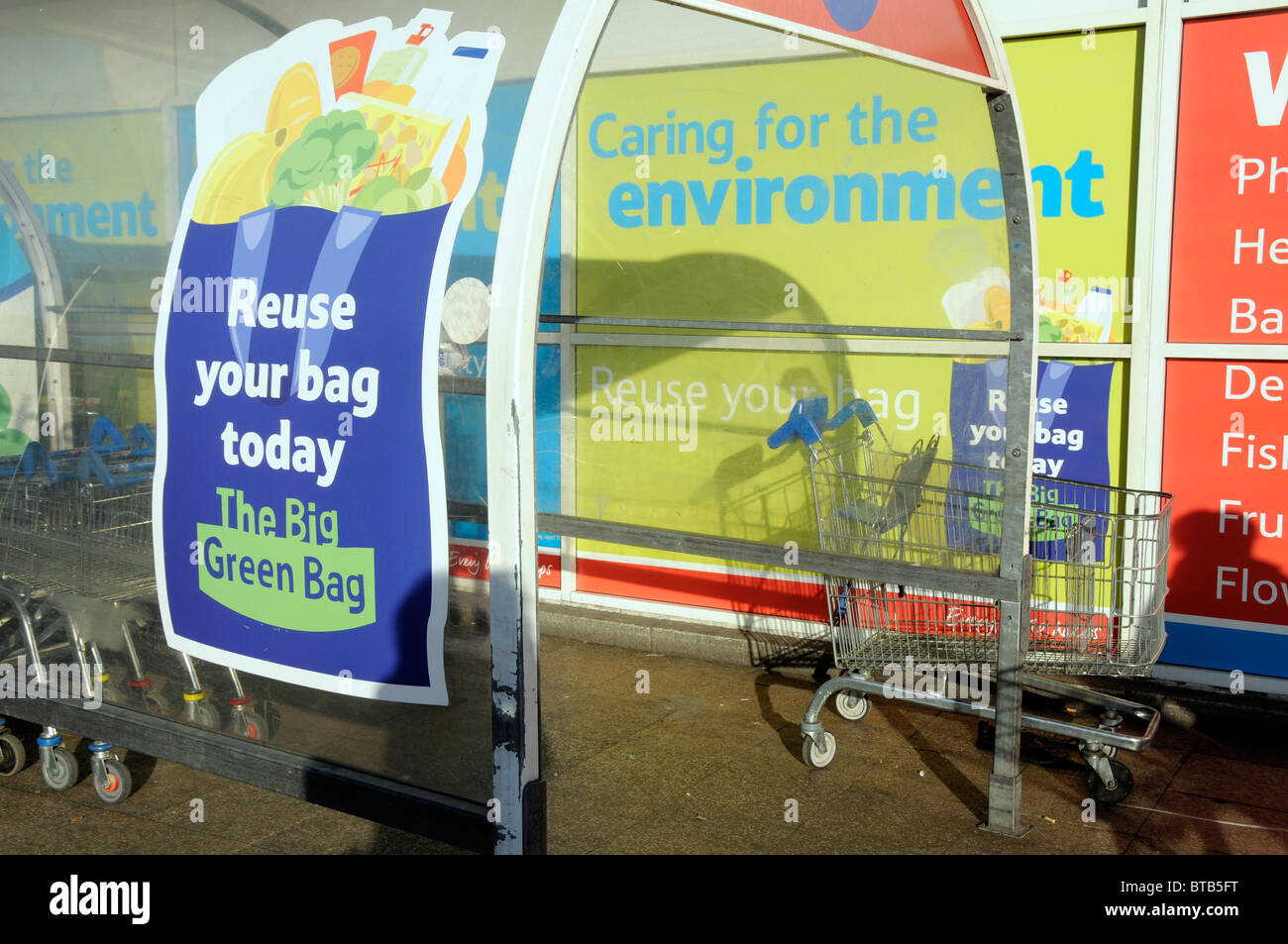 UK Plastic carrier bags recycling bins in Tesco supermarket in Hackney, east London Stock Photo