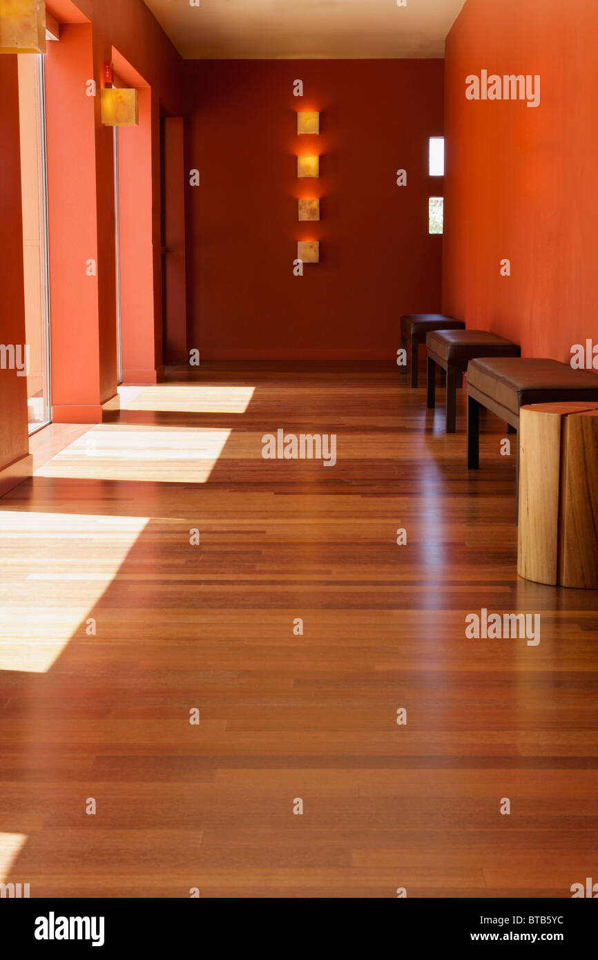 Hardwood floor in hallway with doorways and benches Stock Photo