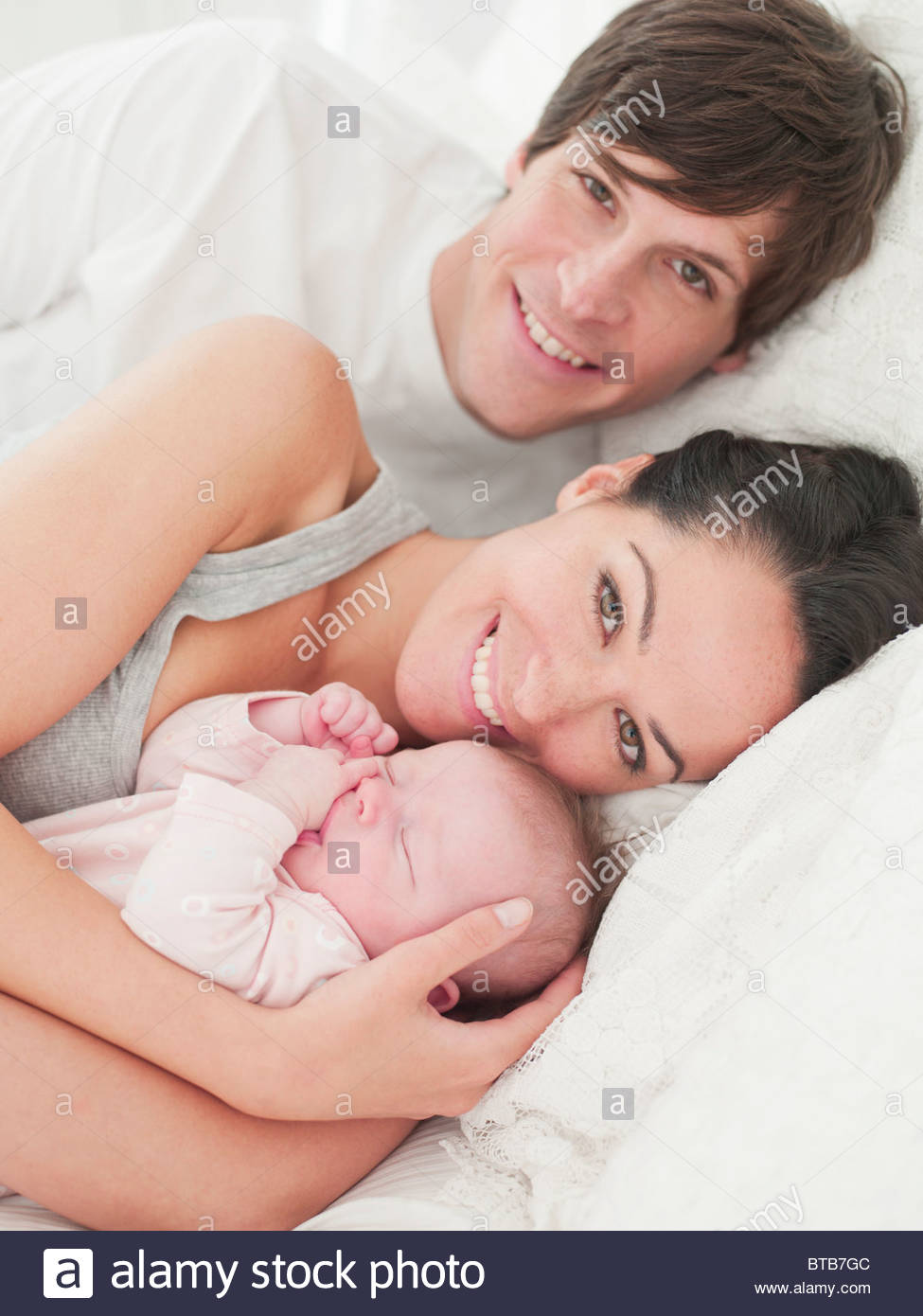 Family Of Three People Sleeping In One Bed Stock Photos & Family Of