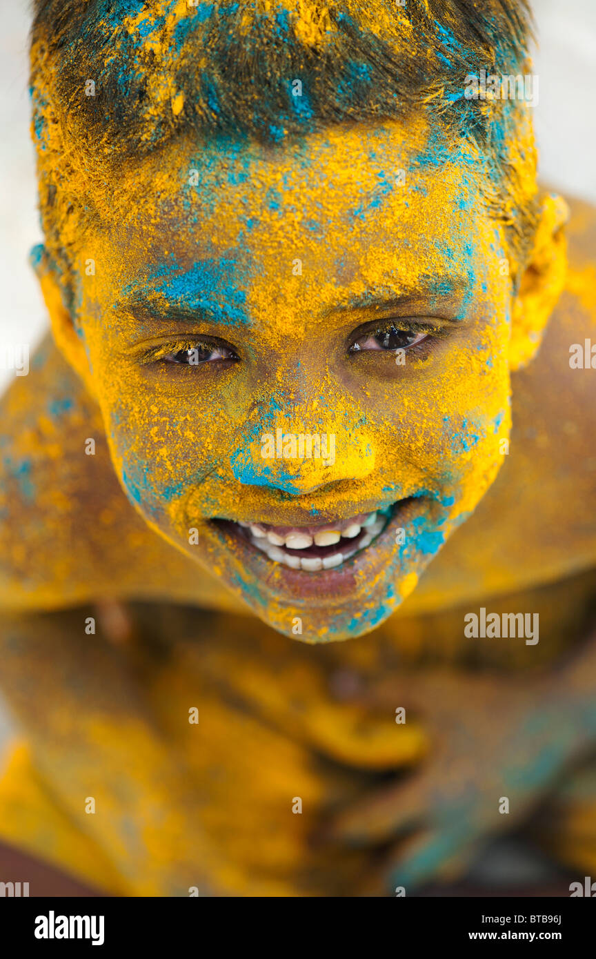 Happy young Indian boy covered in coloured powder. India Stock Photo