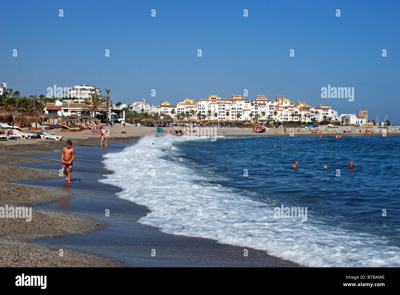 Holidaymakers on the beach, Puerto Banus, Marbella, Costa del Sol, Malaga Province, Andalucia, Spain, Western Europe. Stock Photo