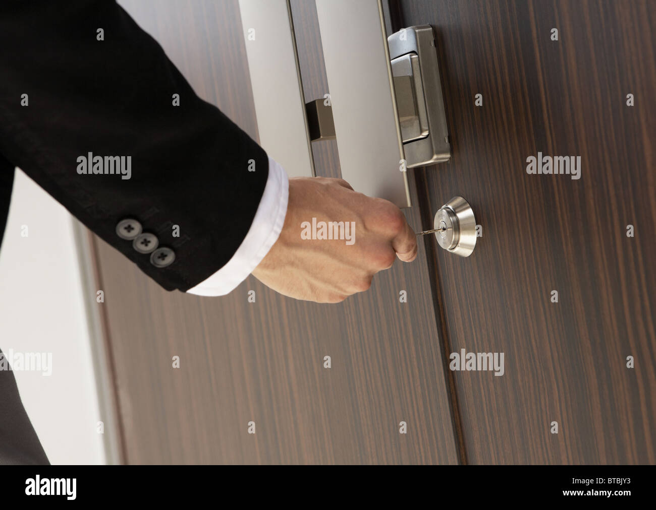 Close up of mans hand locking door Stock Photo Alamy