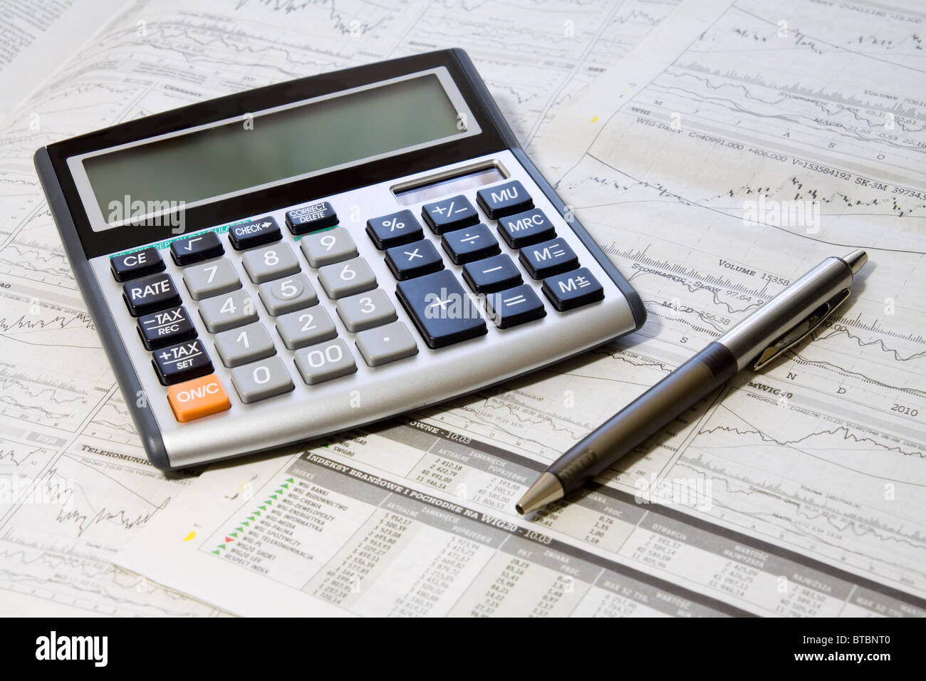 Pen, Calculator On A Financial Newpaper. Shot in studio. Stock Photo