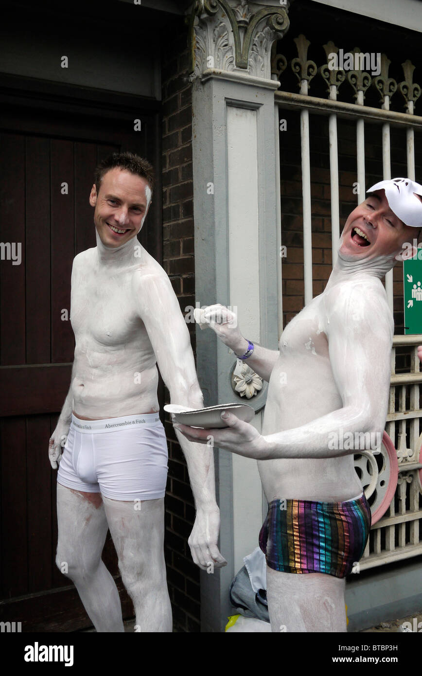 Gay Men enjoy being photographed while applying body paint prior to the 2010 Manchester Pride Parade in the City Centre, England UK Stock Photo