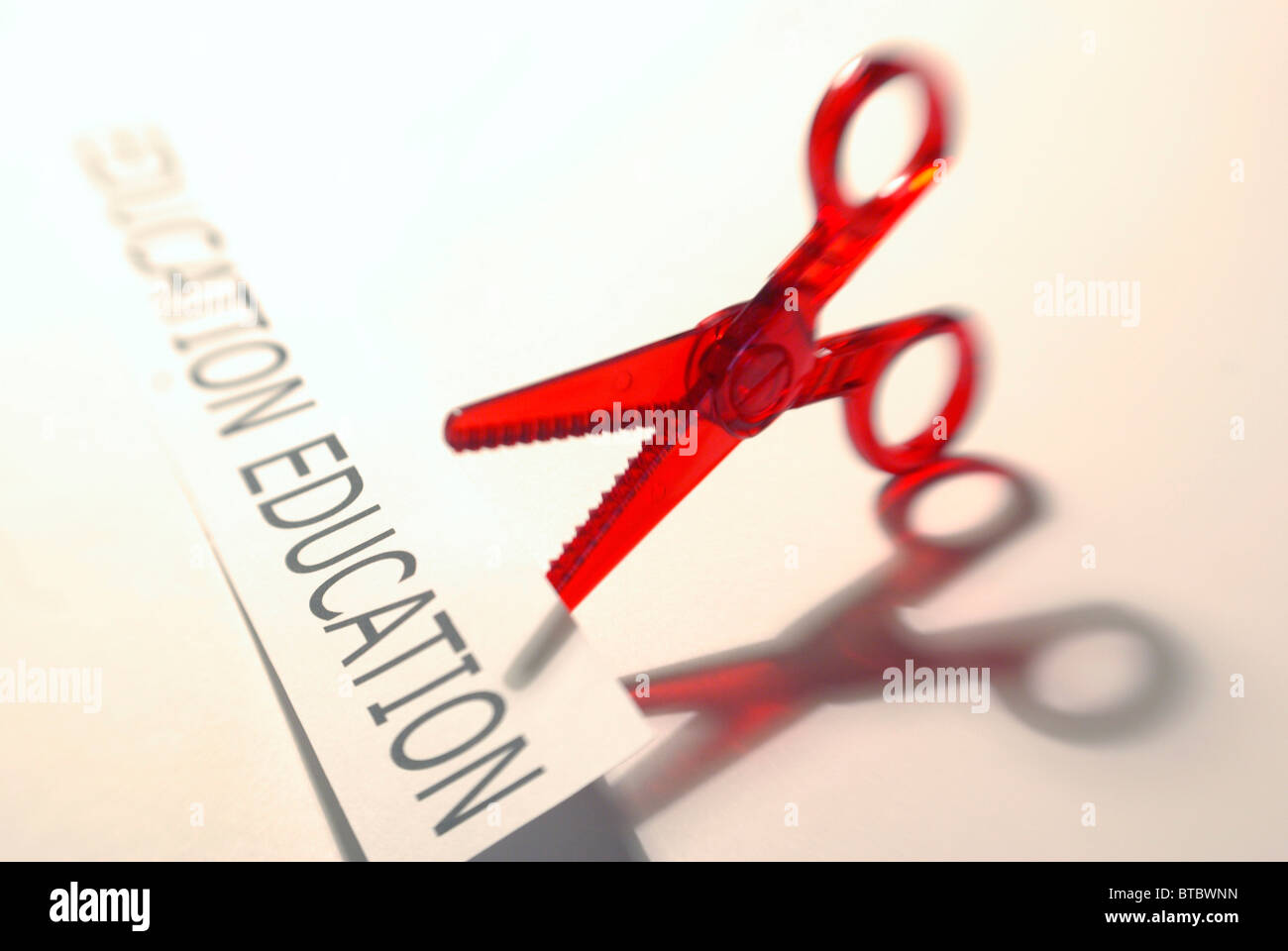 Education cuts concept featuring scissors and education  graphic Stock Photo
