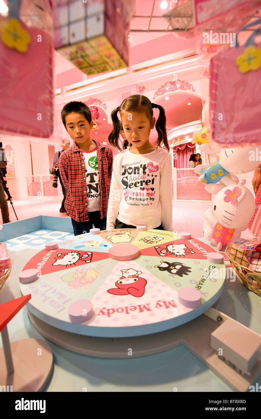 Young visitors play a Hello Kitty craps dice game at the opening of