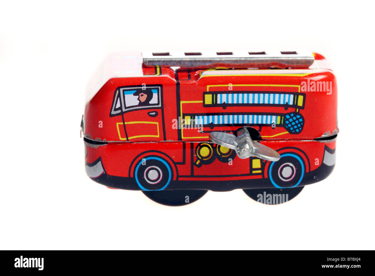 Tin toy, fire engine, wind up motor by a metal key. Stock Photo