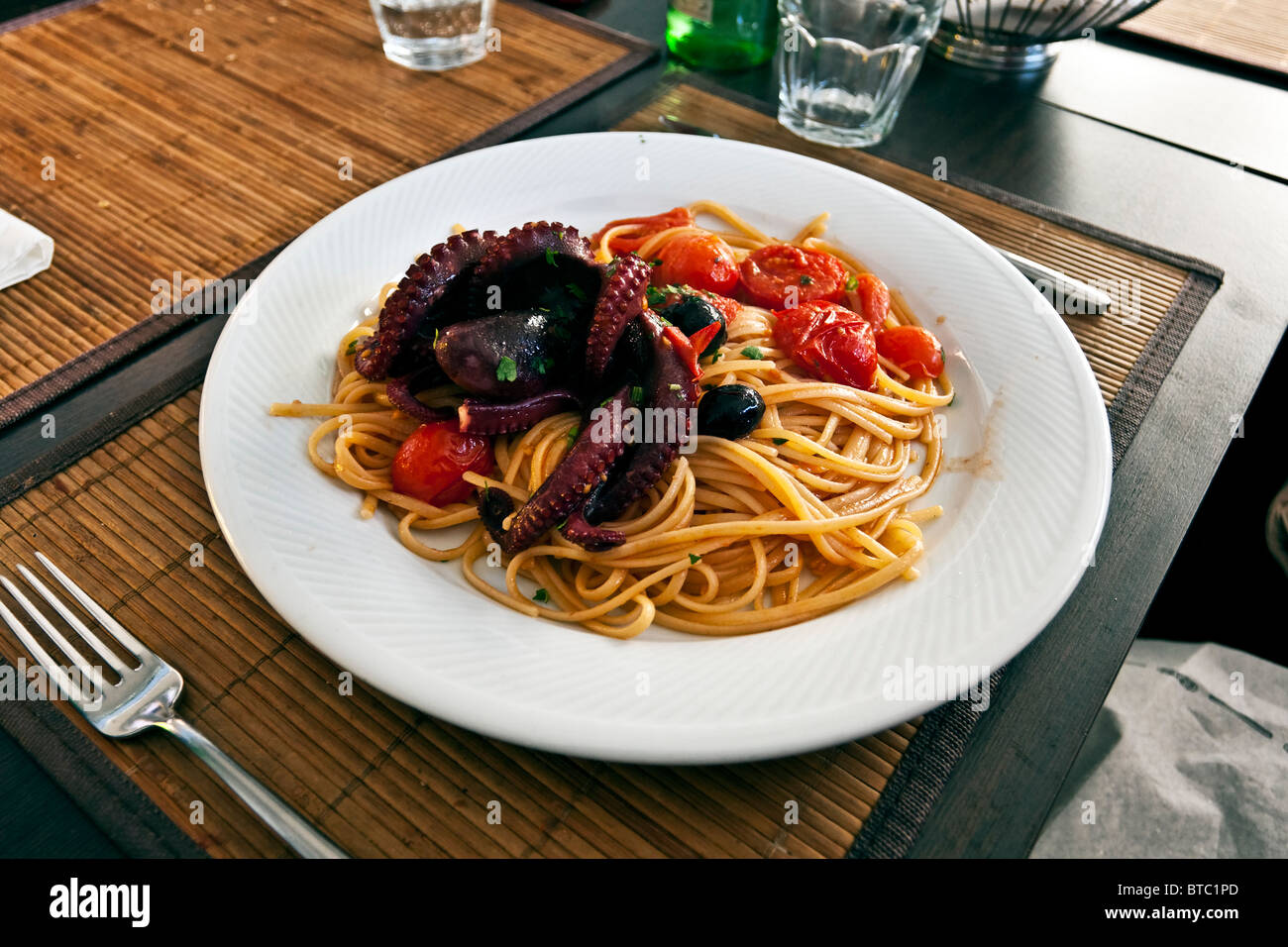 Seafood spaghetti allo scoglio, with octopus and small cherry pachino tomatoes, Naples, Campania, Italy Stock Photo