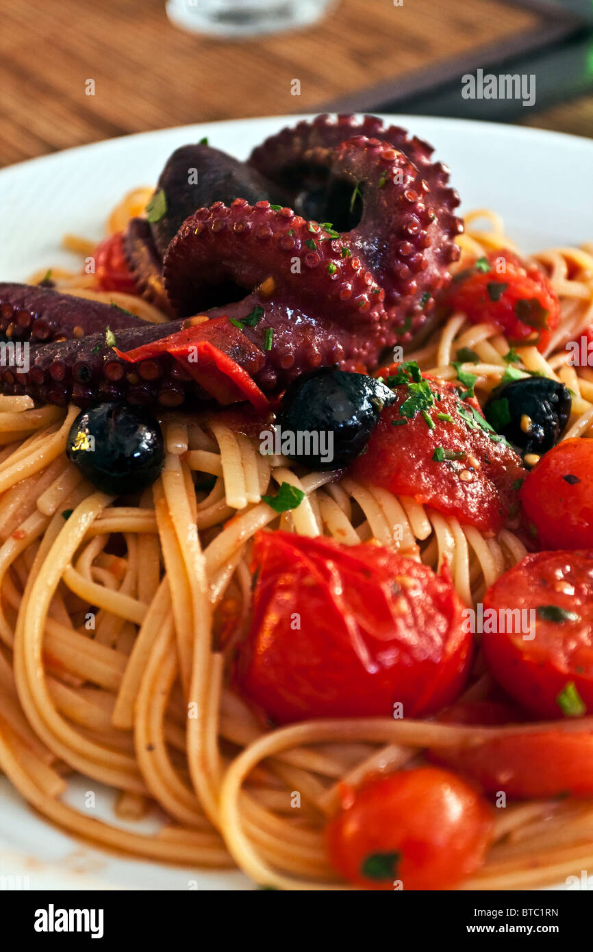 Seafood spaghetti allo scoglio, with octopus and small cherry pachino tomatoes, Naples, Campania, Italy Stock Photo