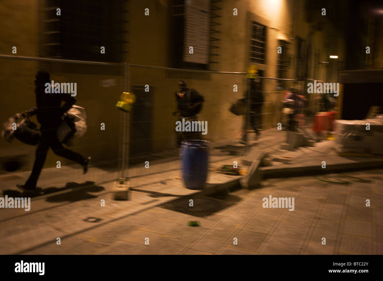 Illegal African street hawkers escape from Carabinieri in Florence's Via di Corti. Stock Photo