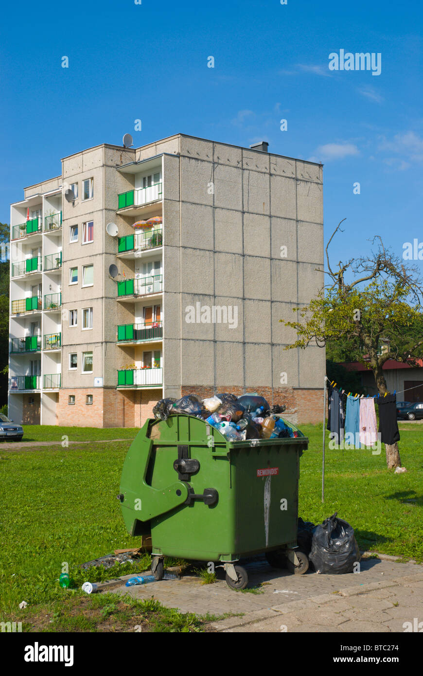Full rubbish bin in front of a residential block Swinoujscie Pomerania Poland Europe Stock Photo