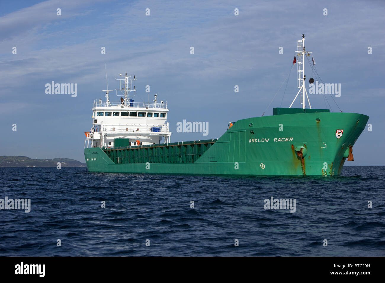 loaded arklow racer irish dry cargo ship at anchor in coastal waters of the uk Stock Photo