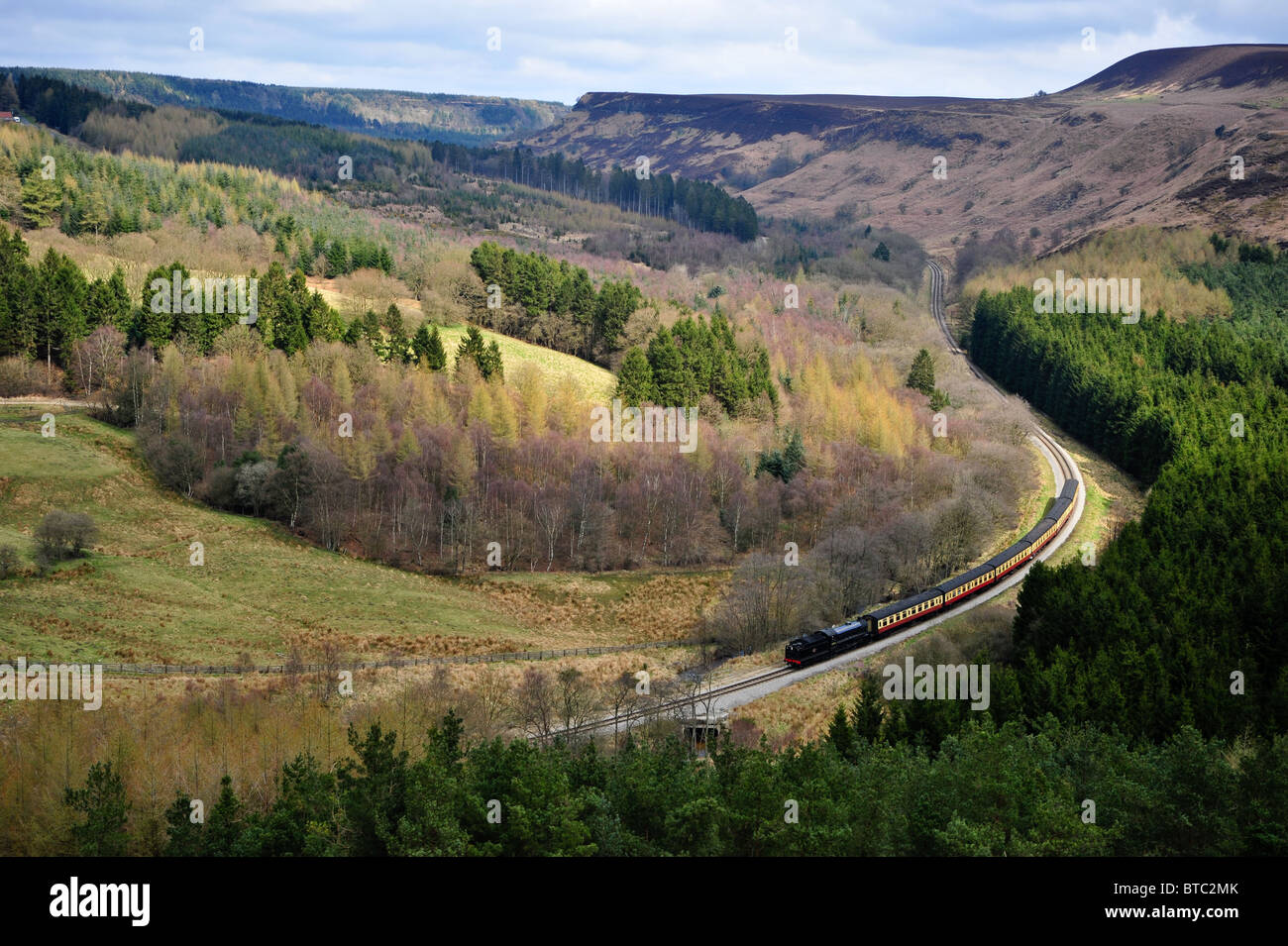 A steam train winds it's way through the North Yorkshire moors Stock Photo
