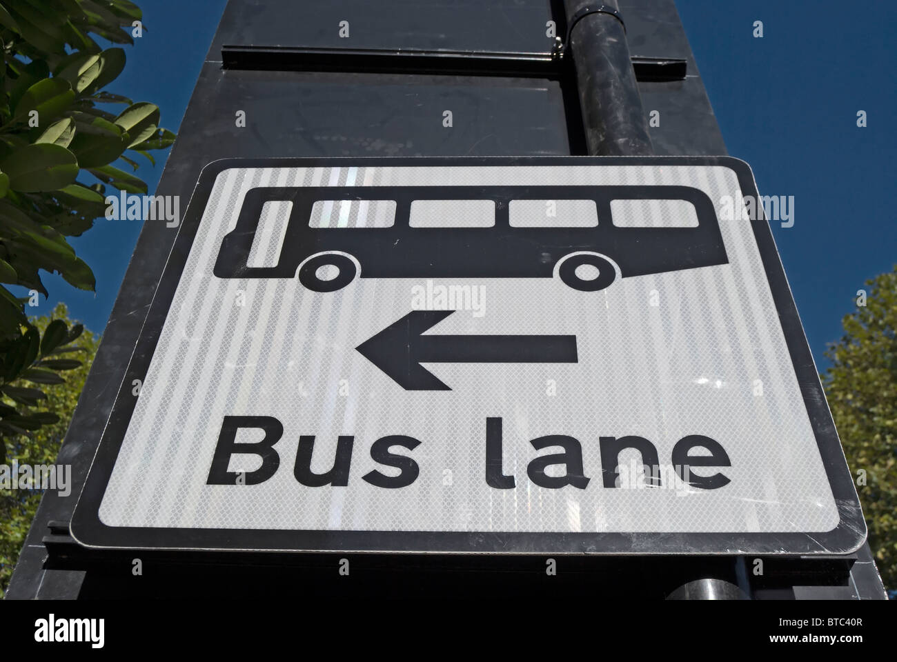 british traffic sign on the approach to a junction indicating a bus lane to the left, in ealing