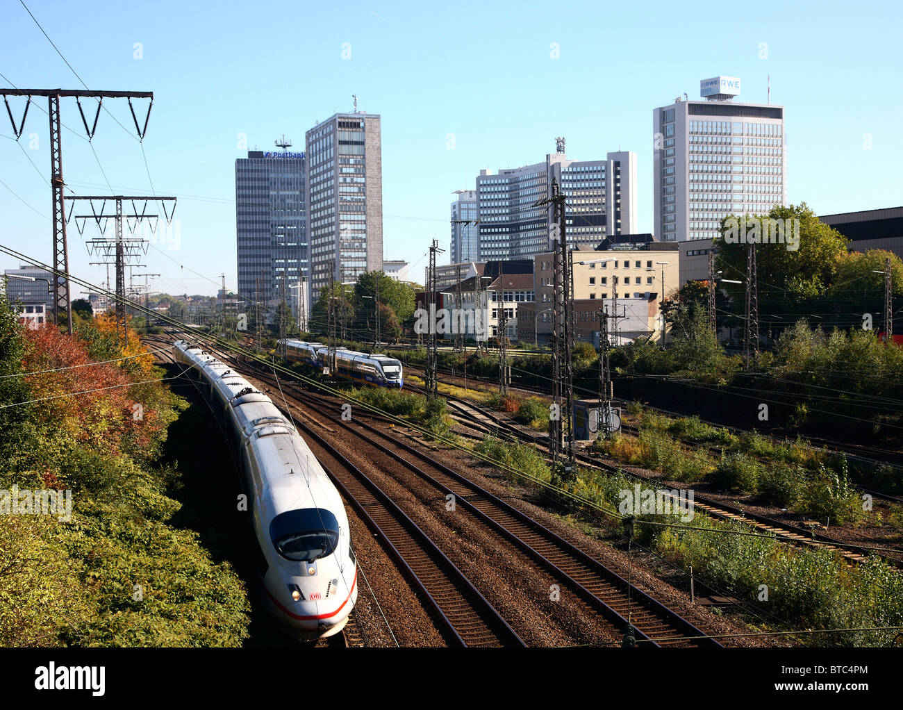 Skyline of Essen, Germany. Business district. ICE high speed train on track. Stock Photo