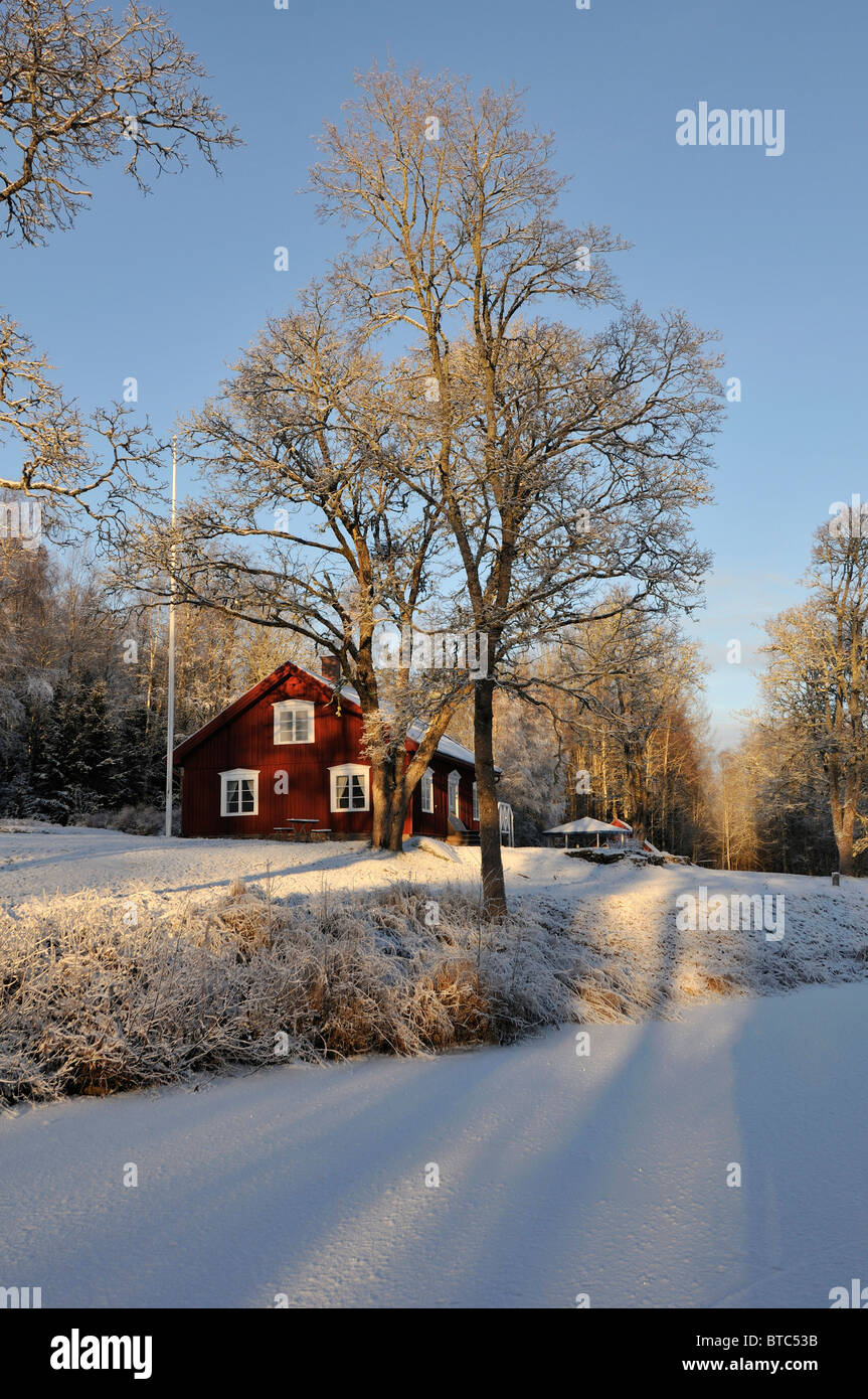 Cottage at frozen creek near Filipstad in winter, Vaermlands Lan, Sweden Stock Photo