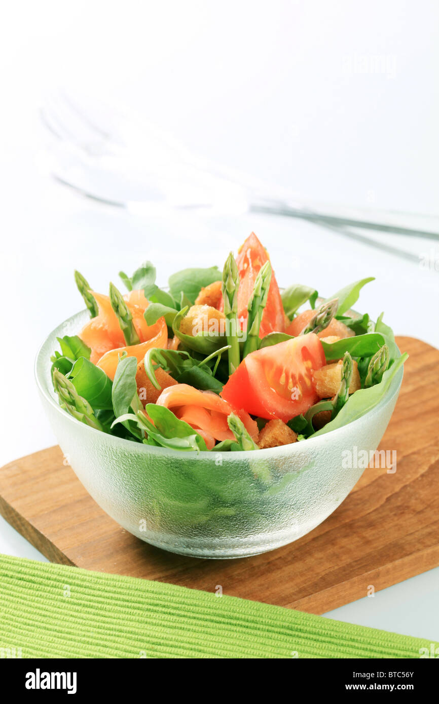 Bowl of greens with smoked salmon and asparagus Stock Photo