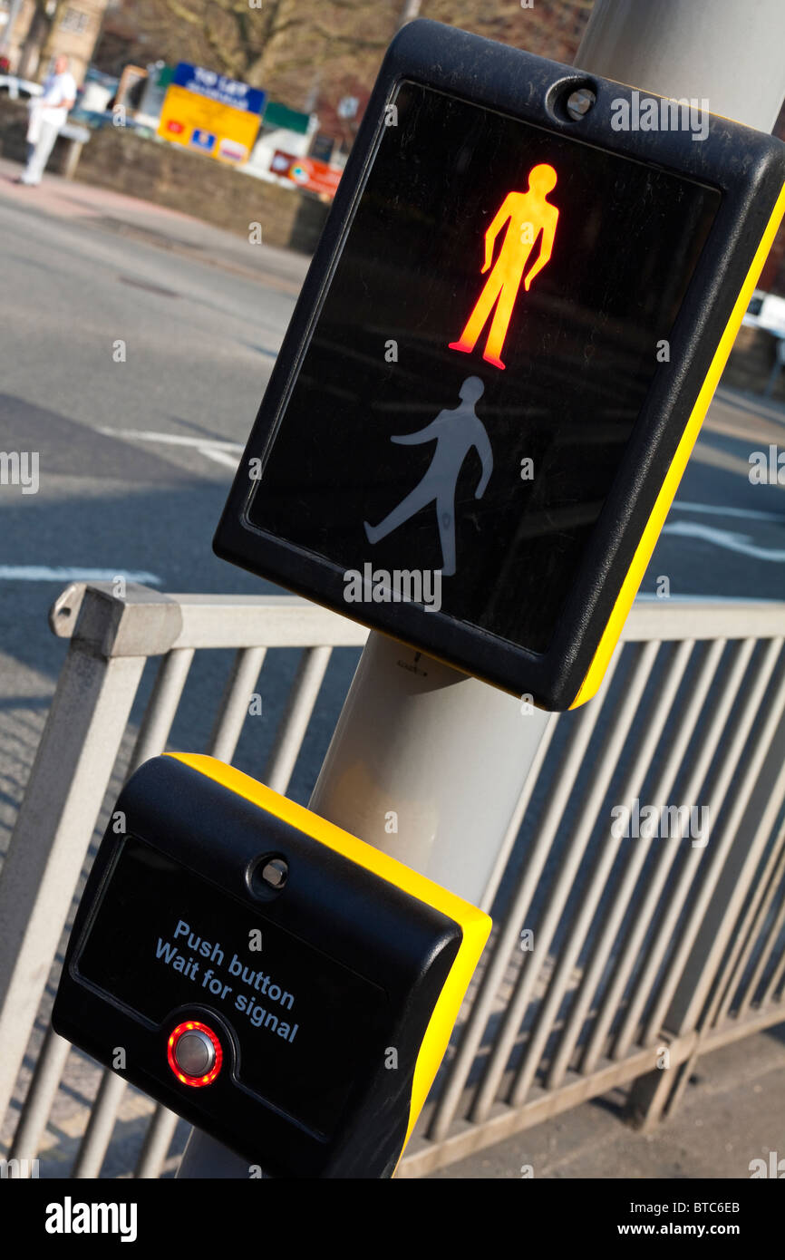 Detail of push button panel on UK Pelican Crossing for pedestrians next to busy road Stock Photo