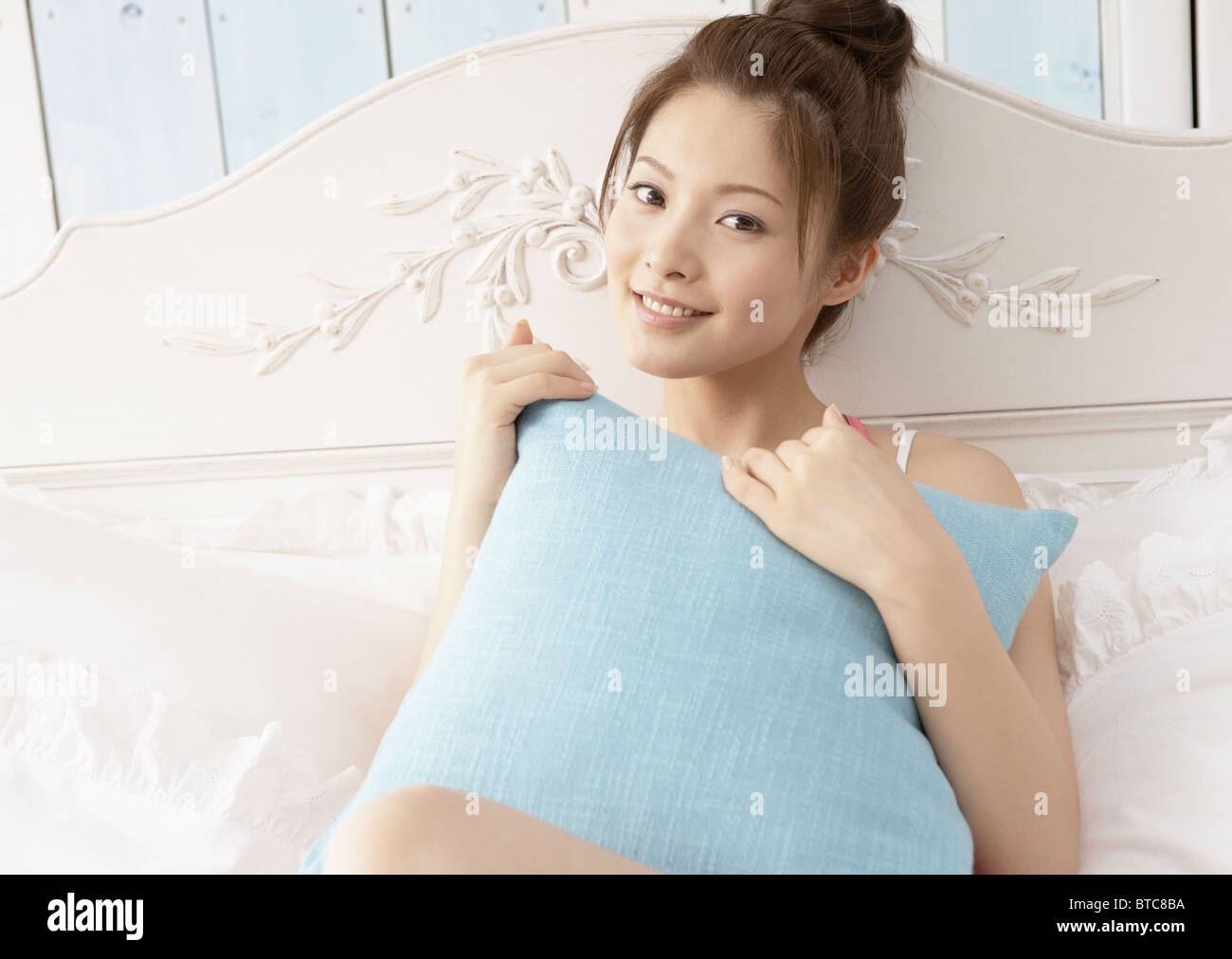 Woman relaxing on bed Stock Photo - Alamy