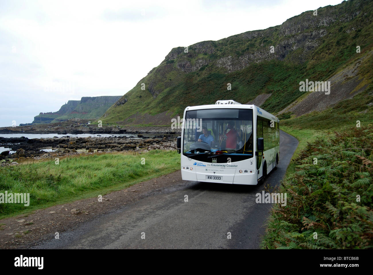 Tourist bus on the road near the Giants Causeway County Antrim