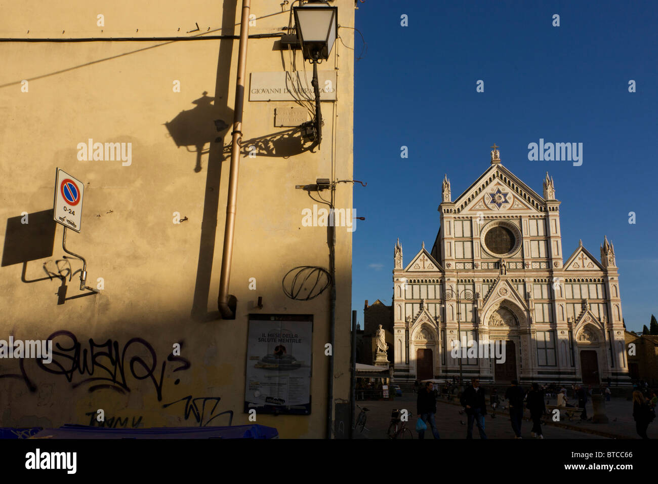 Graffiti street corner and tourist kiosk near Florence's Piazza Santa Croce. Stock Photo