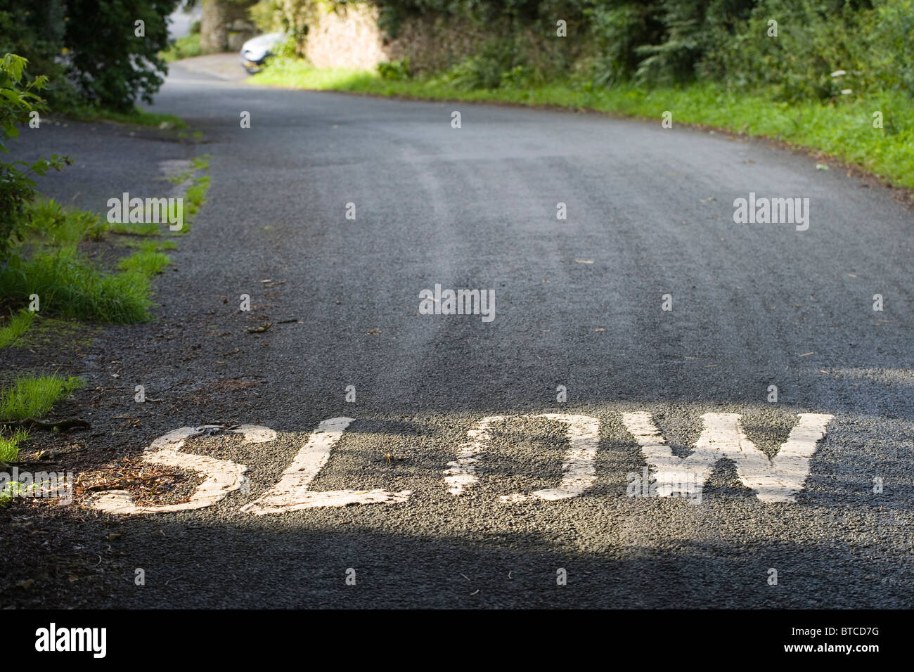 Road Sign, Slow. Warning to oncoming vehicles on an incline. Lancashire, England, UK Stock Photo