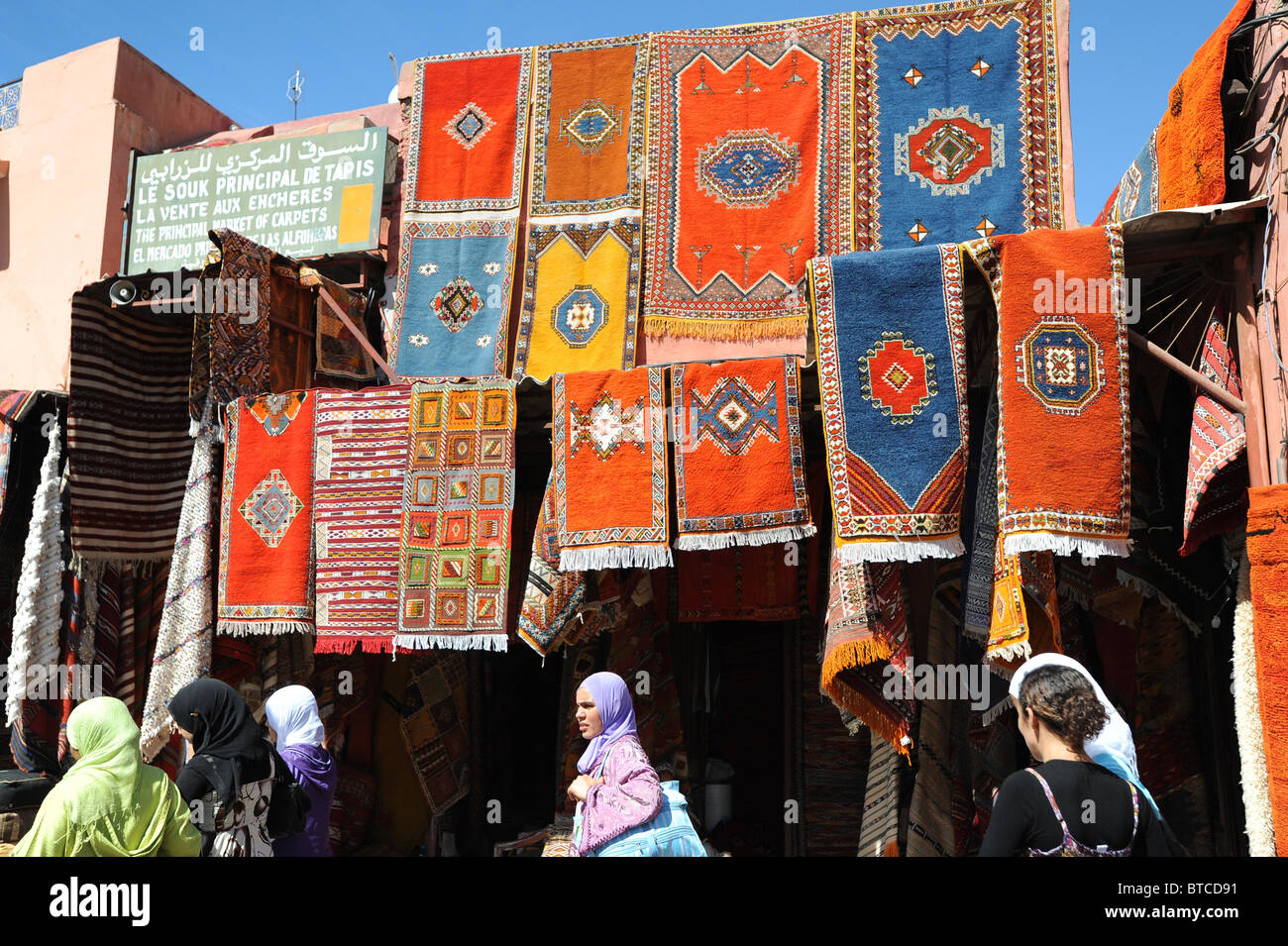 Carpets displayed above shop in Market Place near Djemaa El Fna, Marrakech Stock Photo