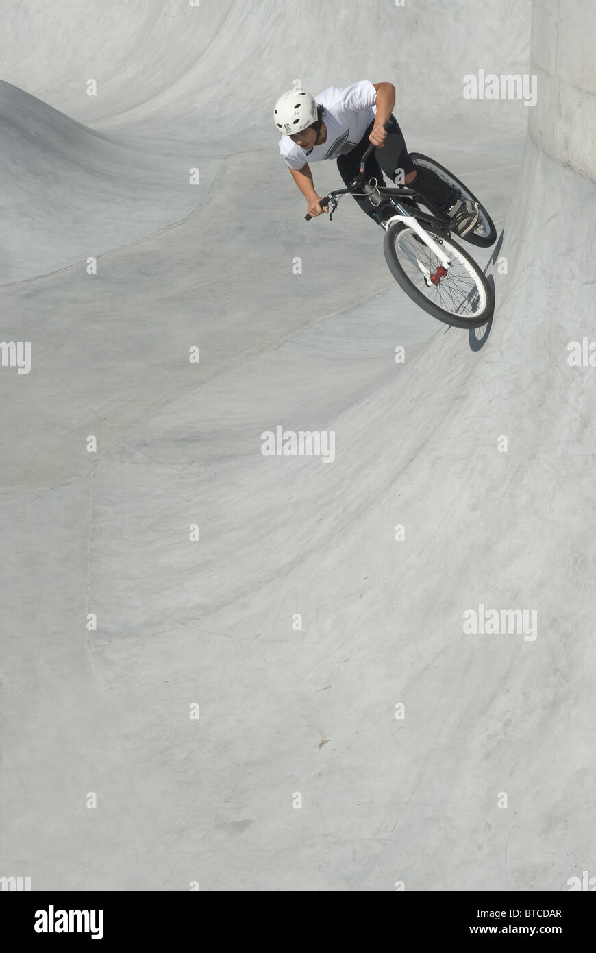 Youth Riding the Wall at the Bike Park Stock Photo