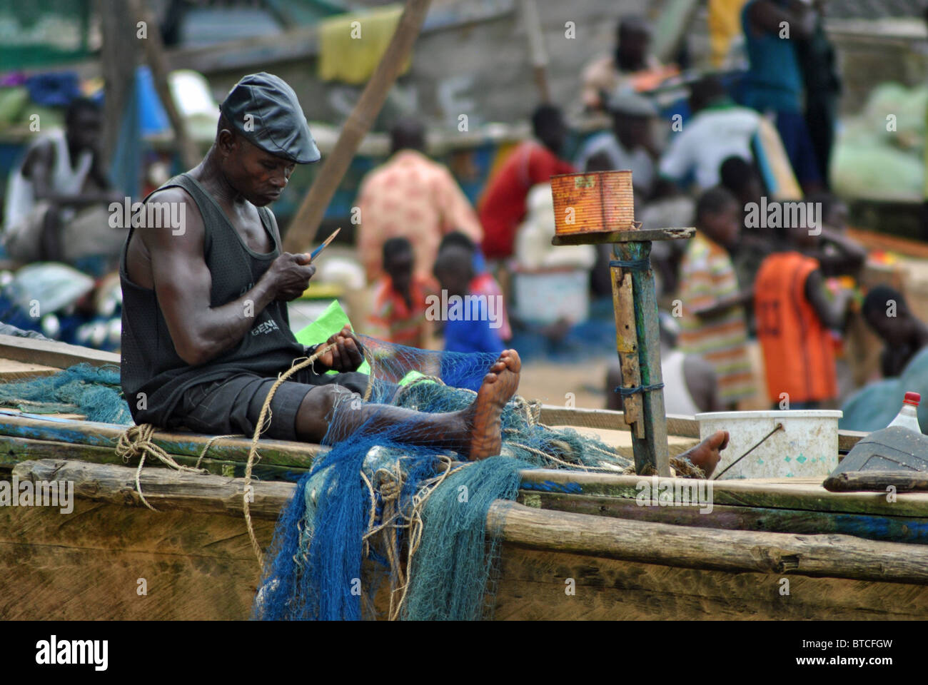 Fisherman mending nets in Sassandra, Ivory Coast, West Africa